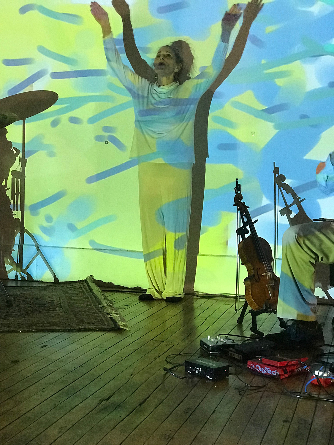 patricia nicholson dances in front of a colorfully painted wall