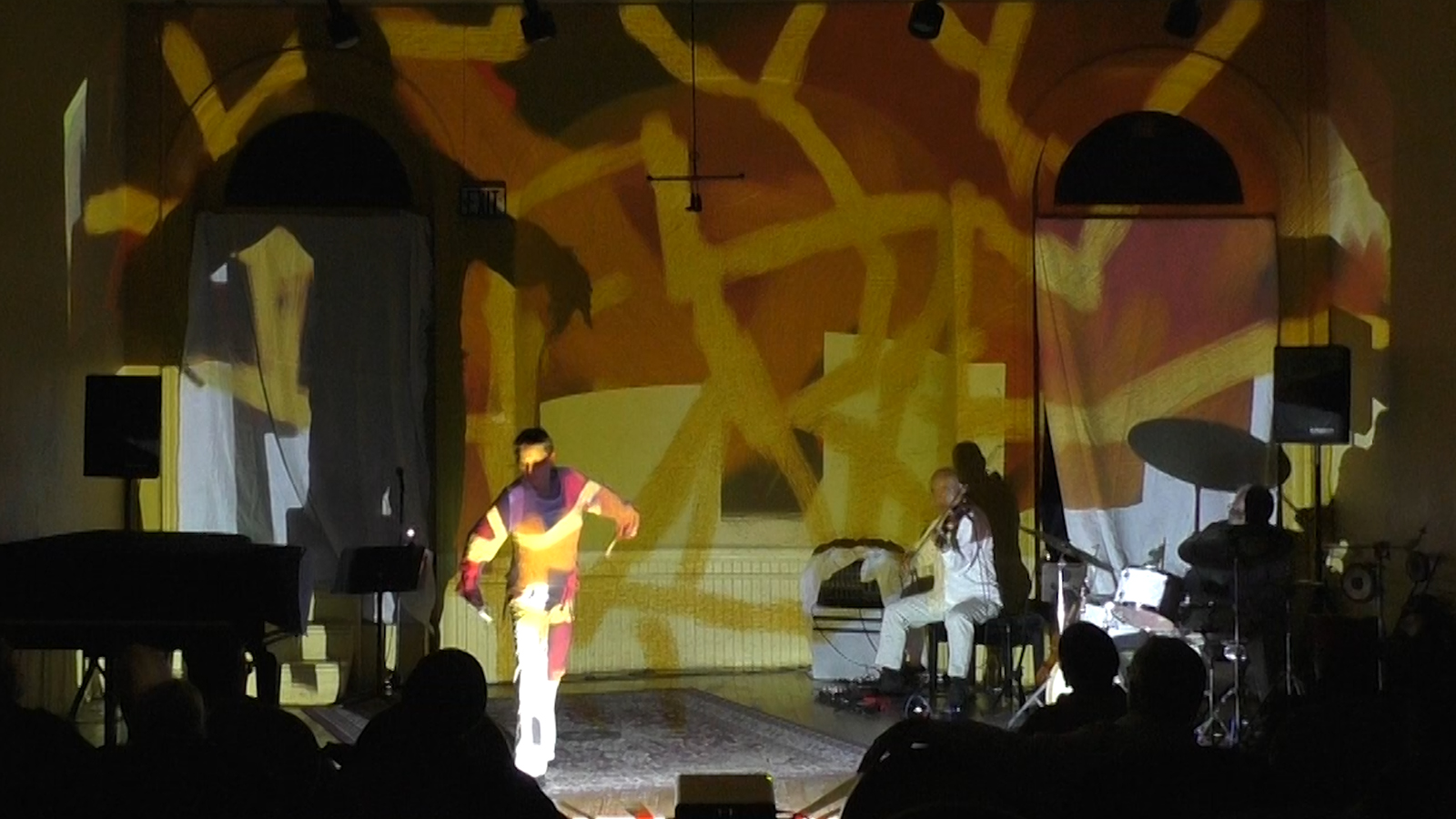 Patricia Nicholson - dance, Jason Kao Hwang - viola, Michael TA Thompson - drums on a colorful stage